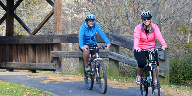 Photo of couple bike riding at Allegany State Park